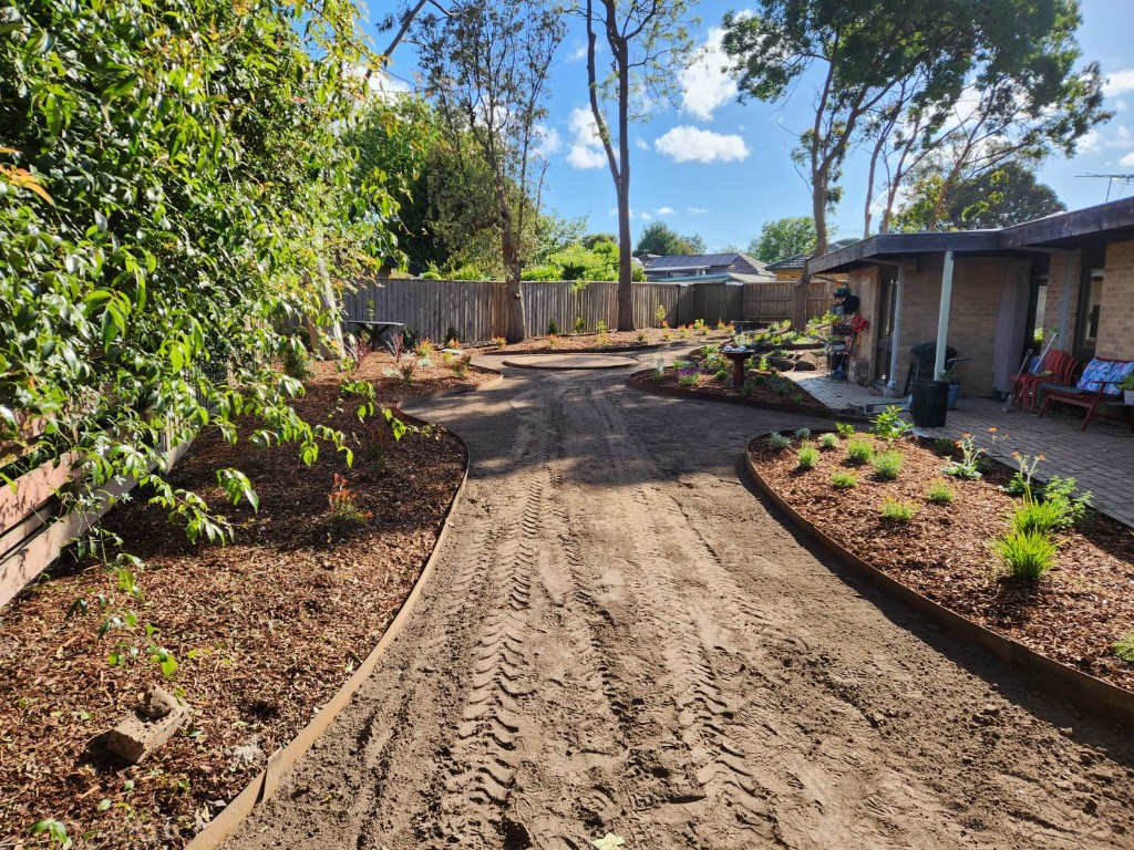 Landscaping in progress with curved path and garden edging