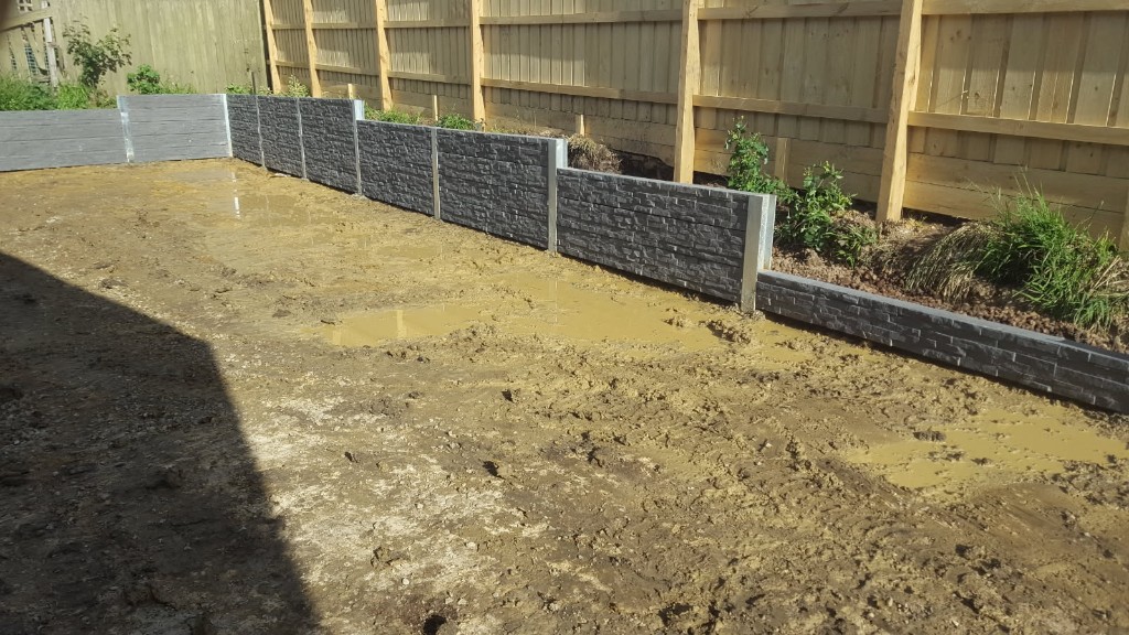 Tiered retaining wall installation with concrete sleepers