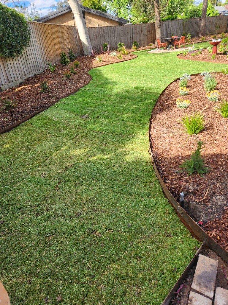 Complete backyard renovation with turf, edging and mulch